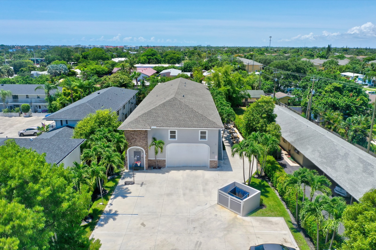Aerial view of the Ebb Tide residence at 350 W Pine Street, West Palm Beach — stucco building, palm trees, private lot