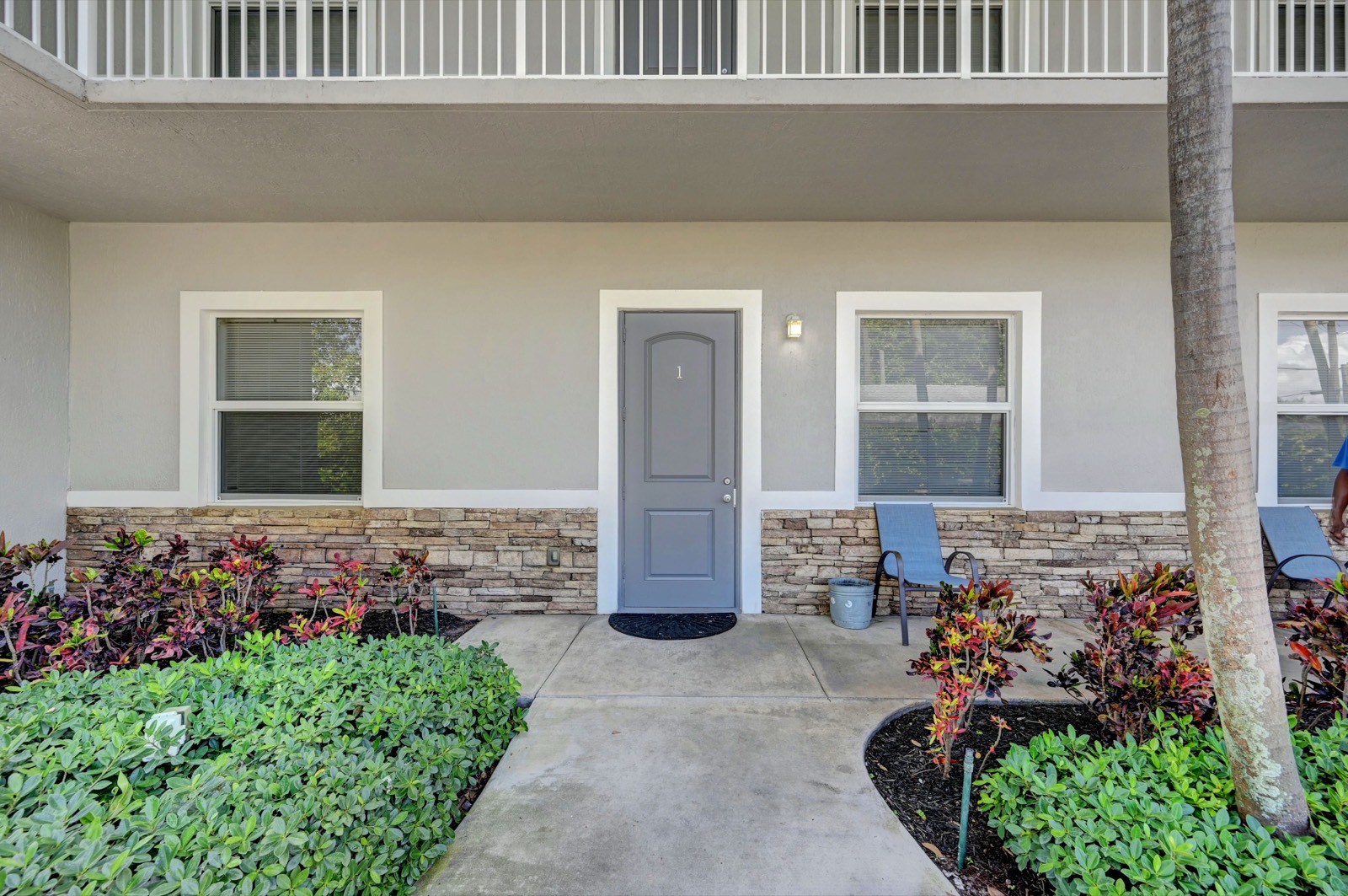 Front entrance of the Ebb Tide residence — covered walkway, landscaping, welcoming approach