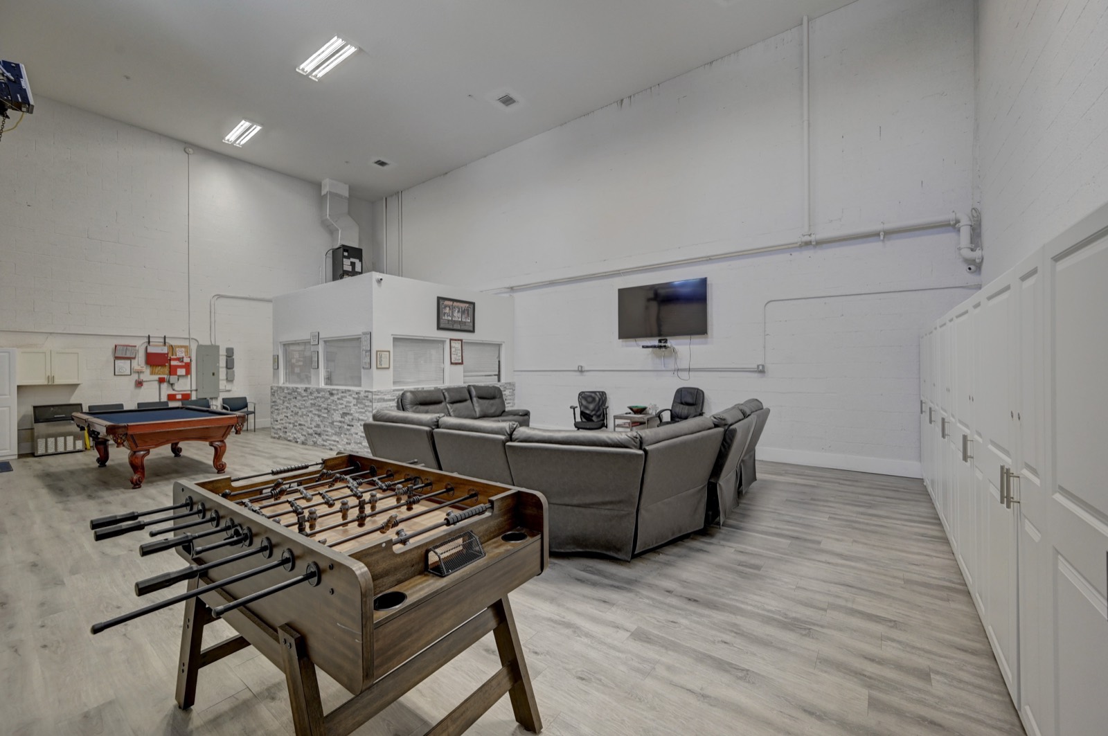 Shared residential lounge at Ebb Tide — foosball, billiards, and common seating